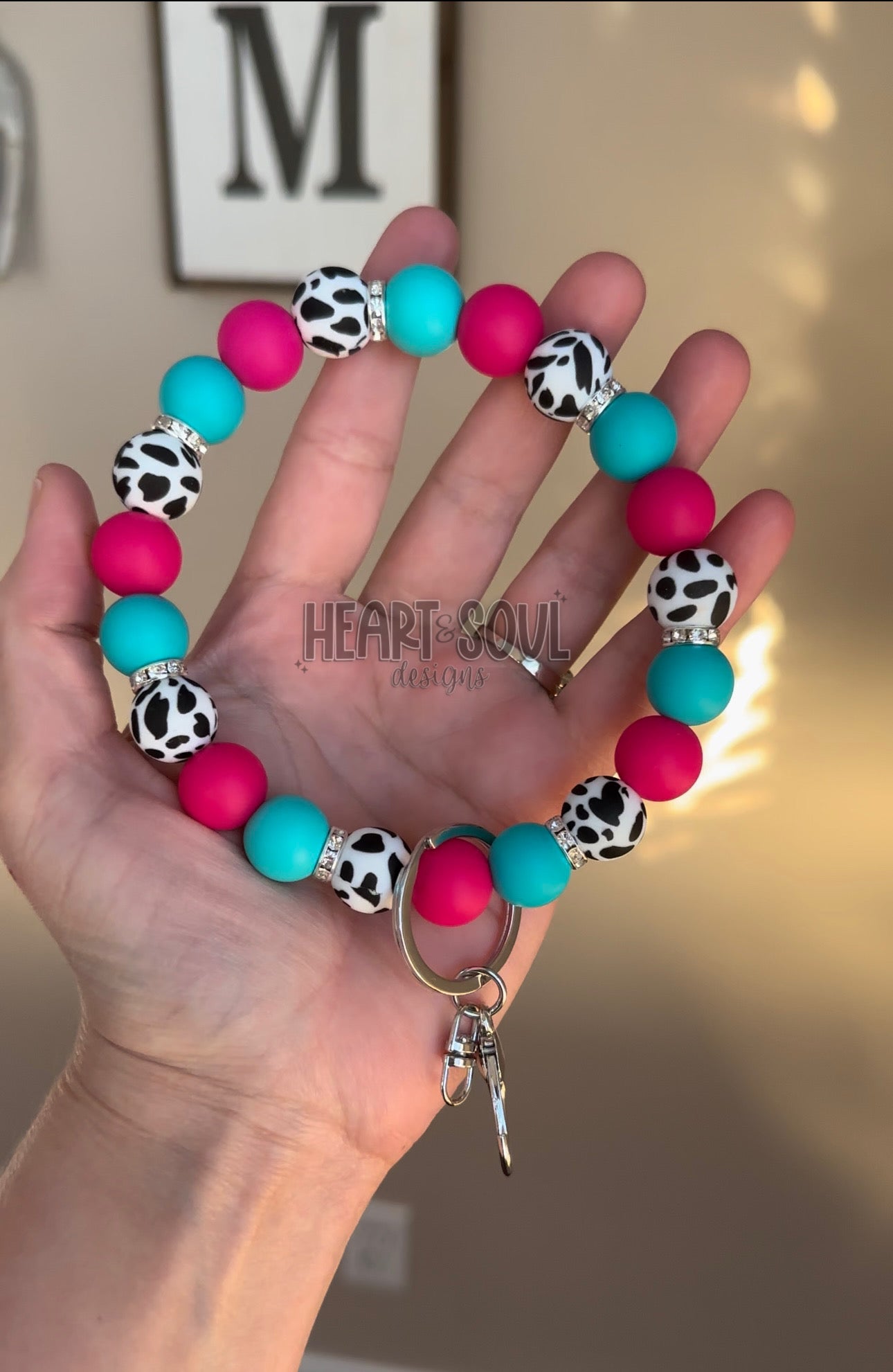Pink and teal cow wristlet