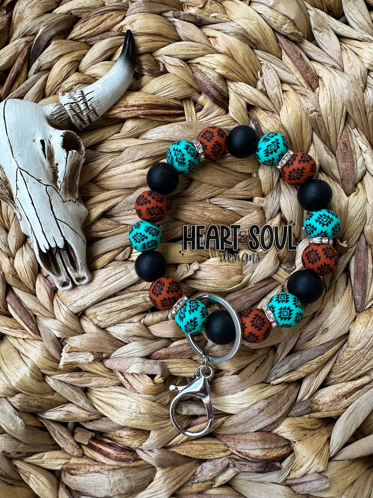 Rust and teal Aztec wristlet