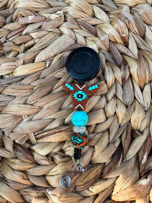 Rust and teal Aztec cow badge reel