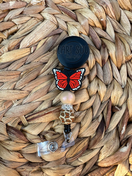 Orange butterfly badge reel